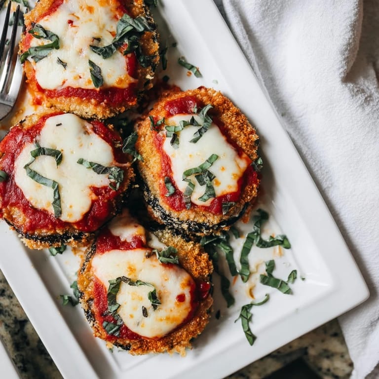 Close-up of cheesy baked Eggplant Parmesan casserole with bubbling mozzarella and rich tomato sauce, ready to serve.