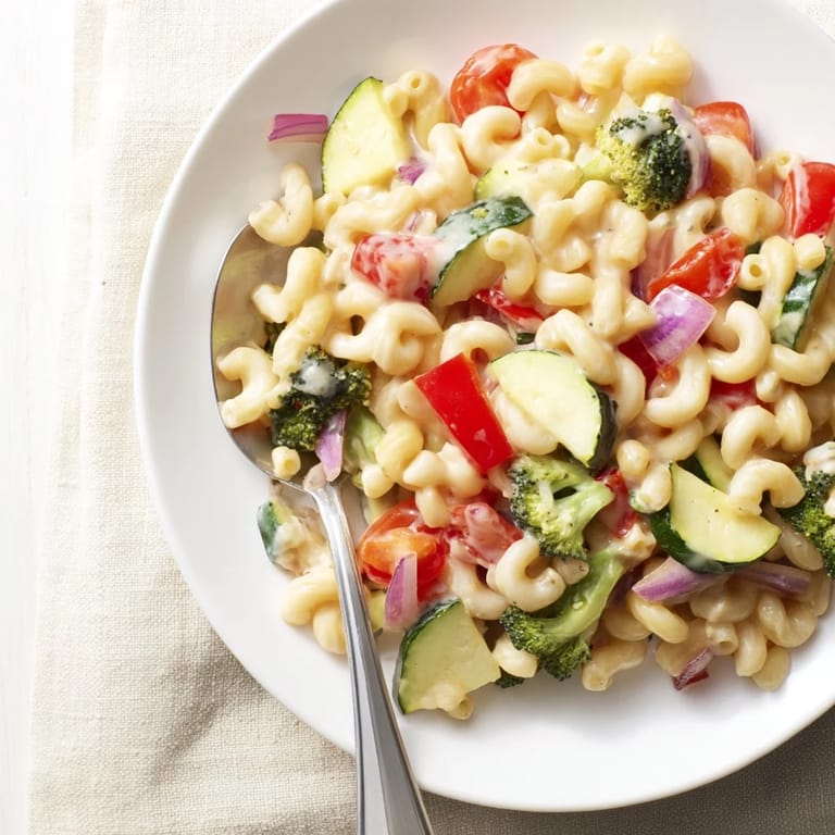 A steaming bowl of roasted veggie mac & cheese, topped with golden Parmesan and served for a family dinner.  