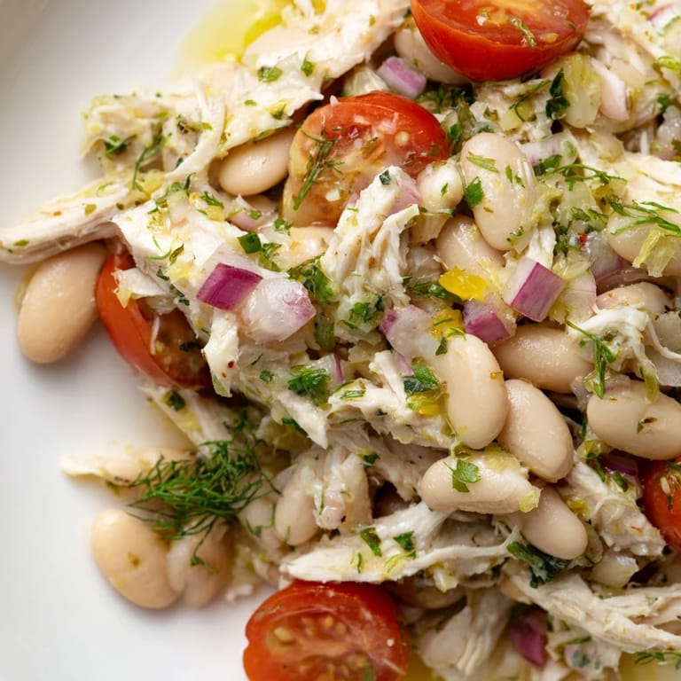 Healthy Lemony White Bean Chicken Salad served on a rustic wooden table, perfect for a light lunch or summer picnic with a gluten-free, high protein focus.