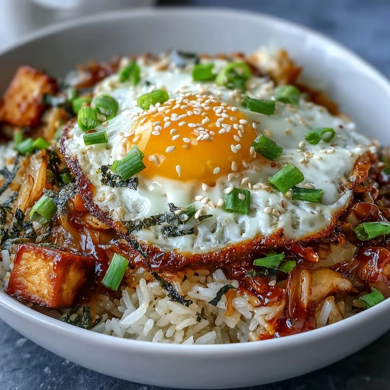 Spicy, tangy kimchi fried rice bowl with fluffy rice carrots and green onions.