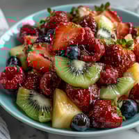 Vibrant Spring Fruit Table Platter with Dipping Yogurt Sauce, featuring colorful berries, tropical fruits, and a creamy honey-lemon yogurt dip.